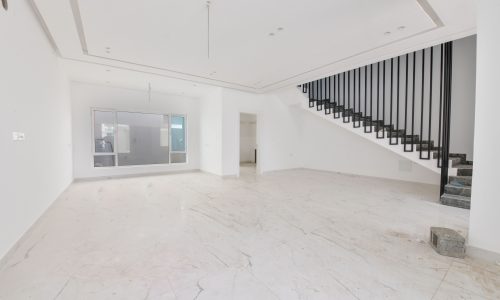 A strategically located white villa with stairs and marble floors.