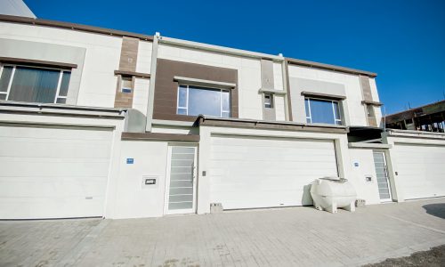 A Luxury Villa with two garages in front of it.