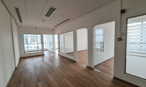 Bright and spacious office for rent in the Seef area with wooden floors and windows.