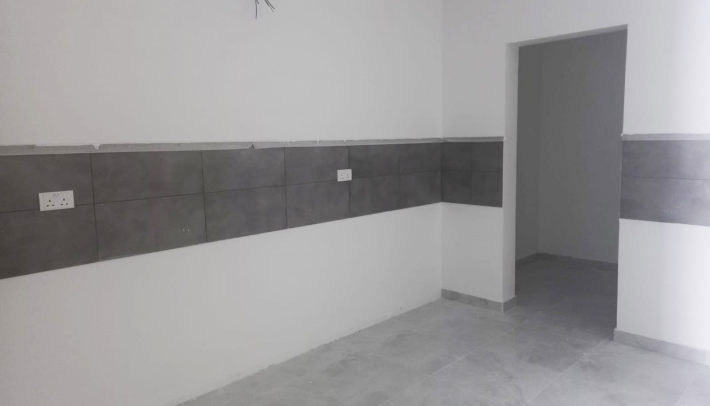 A distinguished villa located in Malkiya, featuring a room with a door and tile walls.