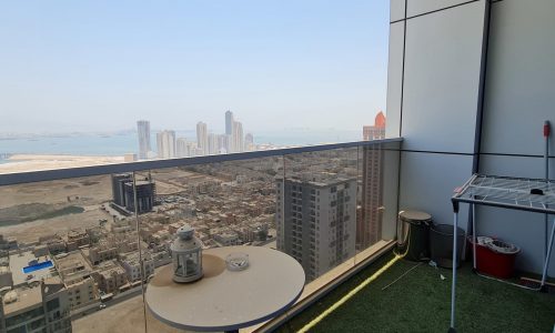 A stunning view of the city from the balcony of a modern apartment.