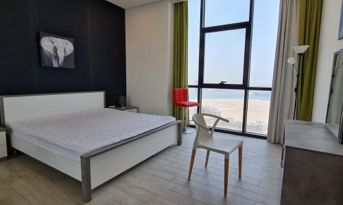 A modern apartment for rent in Juffair with a stunning view of the ocean.