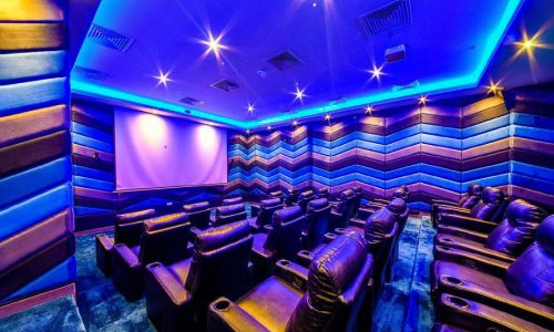 A movie theater with comfortable leather seats.