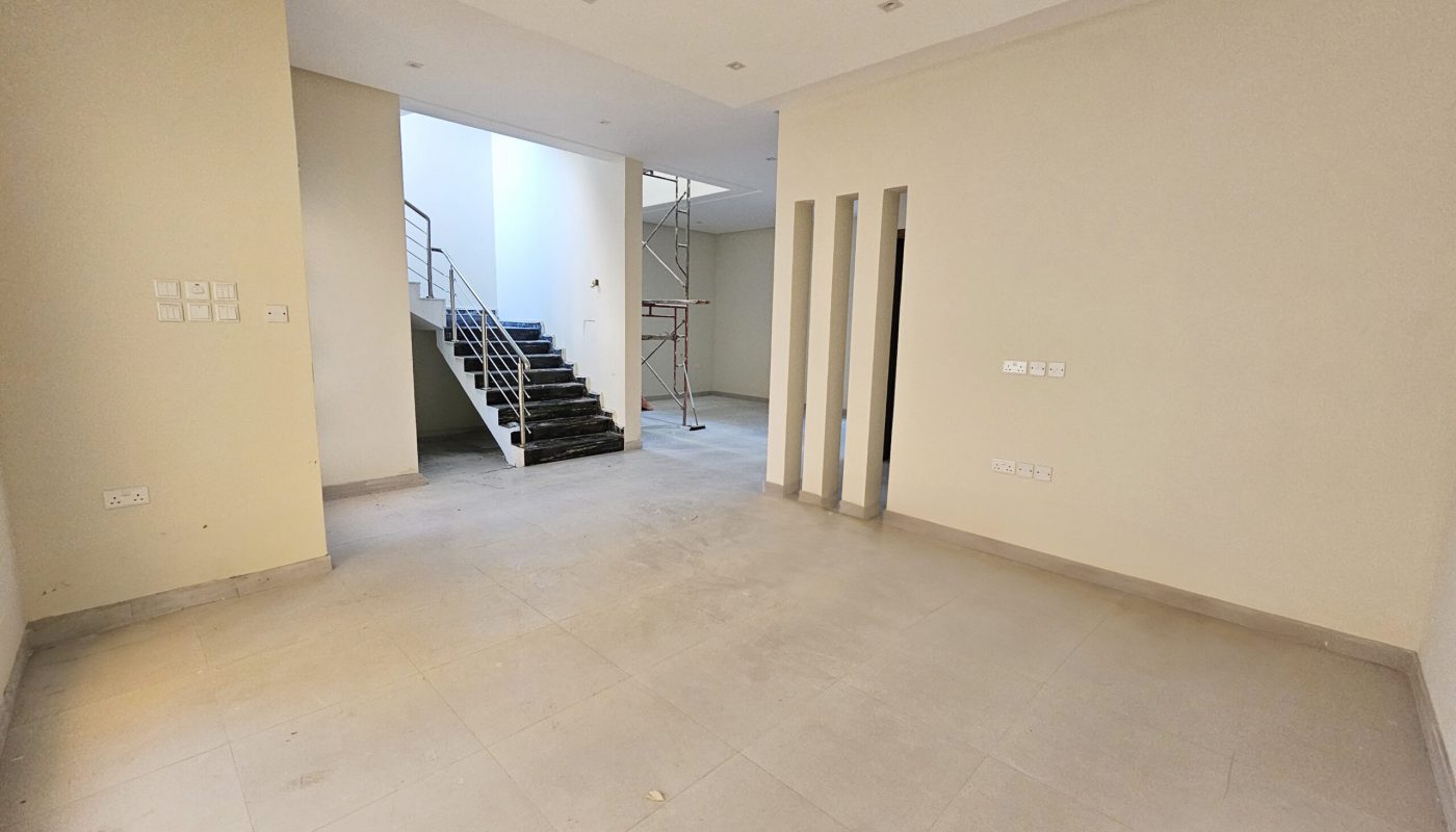 Empty room under construction with unfinished walls, bare floors, and a staircase leading to an upper level, categorized as "Auto Draft.