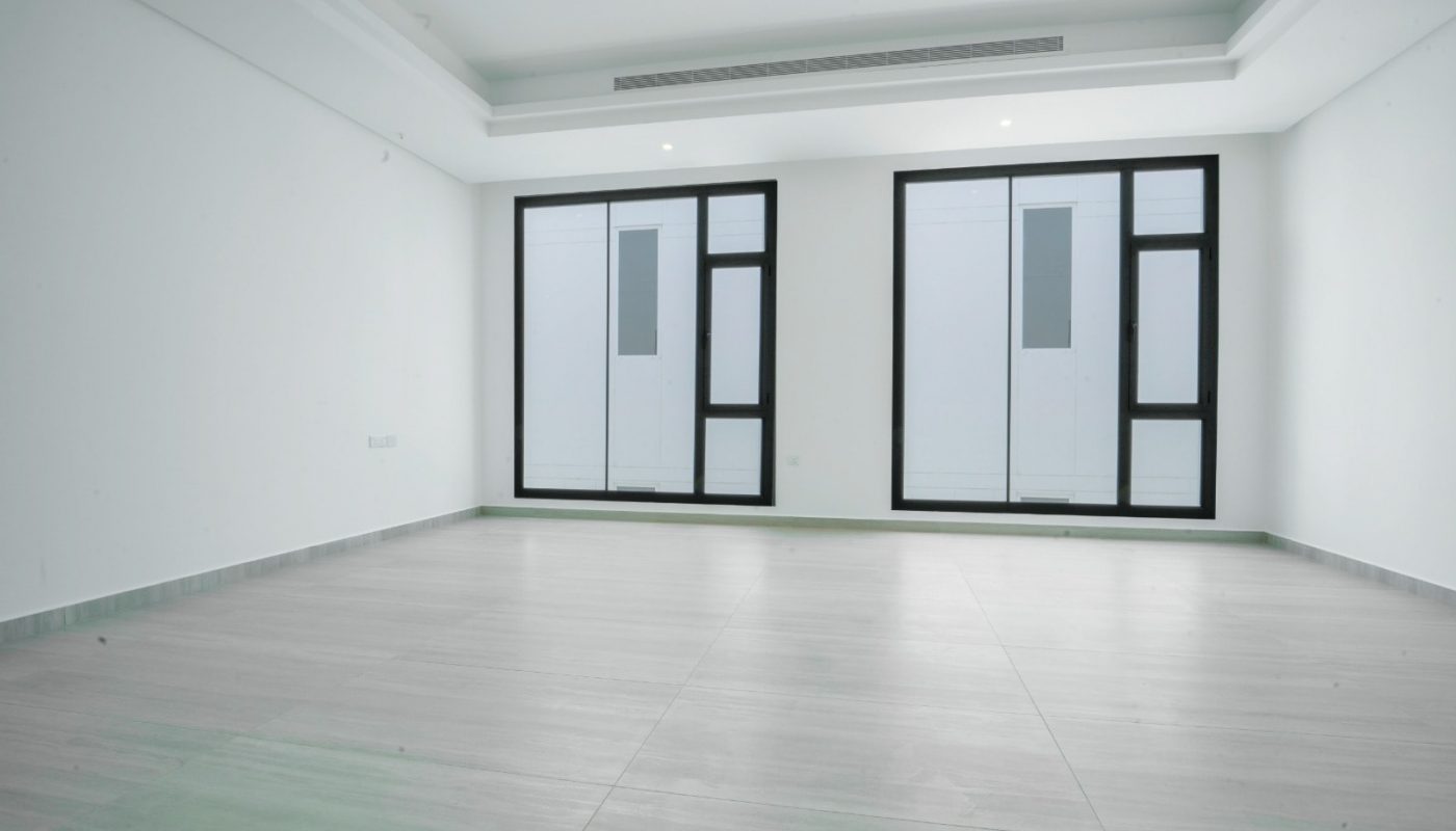 An opulent villa situated in Saraya 2, featuring five bedrooms, large windows, and white walls.