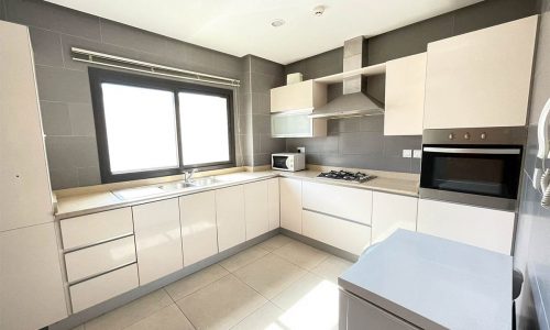 Stunning Apartment with stainless steel appliances and a window.