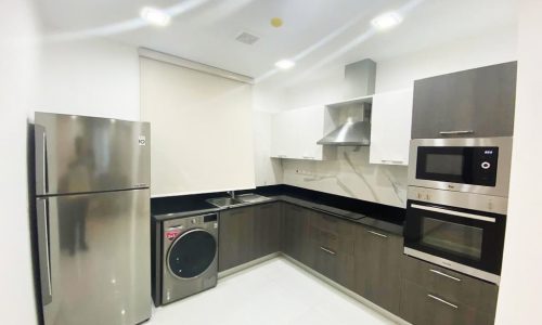 A stylish kitchen with stainless steel appliances and a convenient washer and dryer for rent in Saar near St Christopher's School.