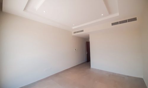 An empty room with white walls and ceiling available for rent.