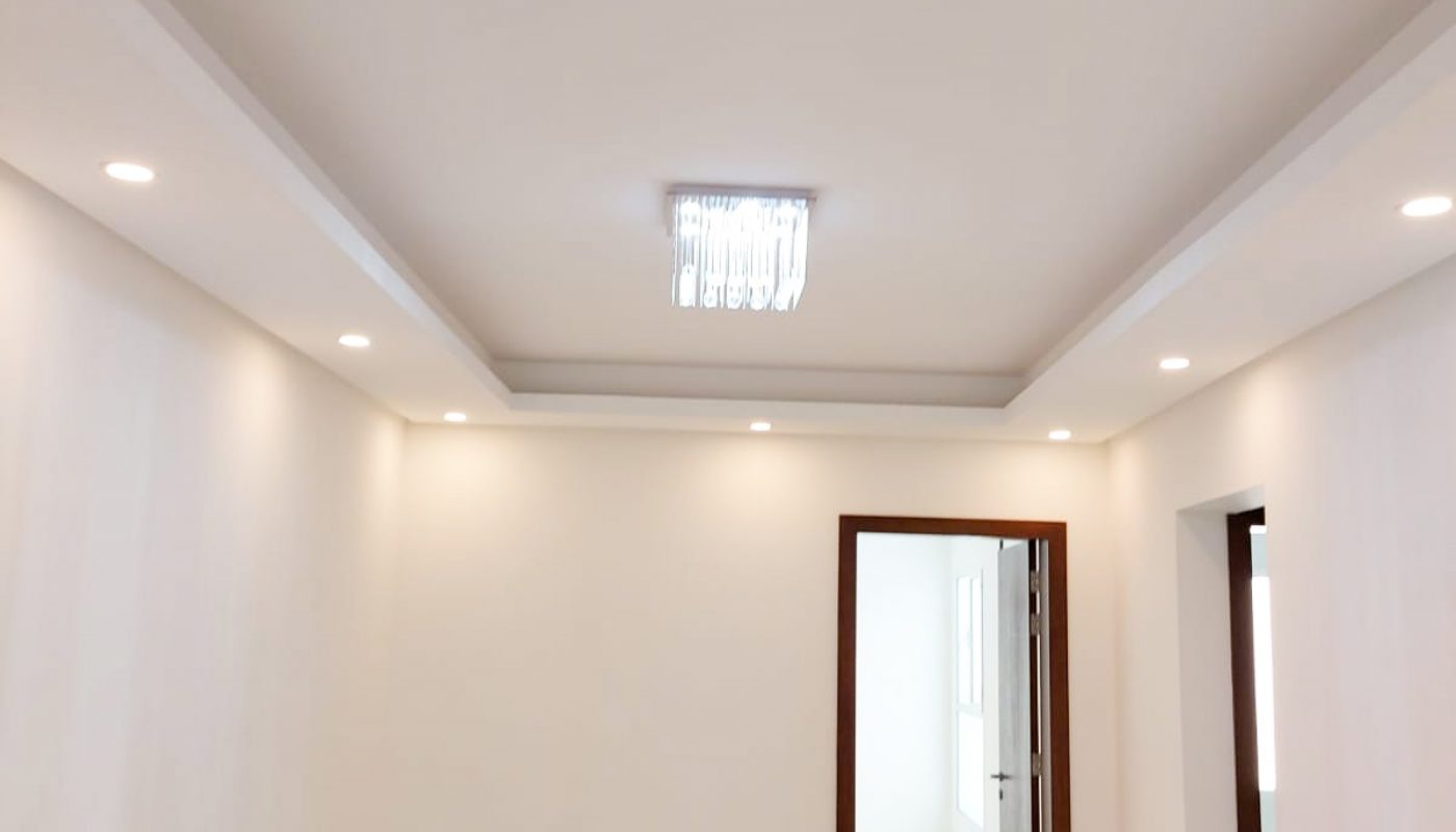 A bright room with white walls and light fixtures.