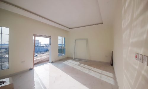 Bright room with a large window and a view of the city.