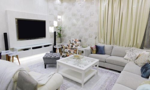 A living room with white furniture.