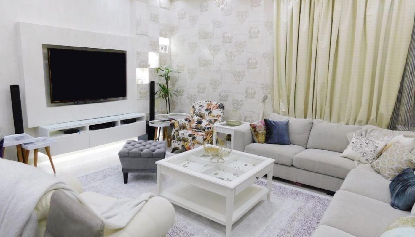 A living room with white furniture.