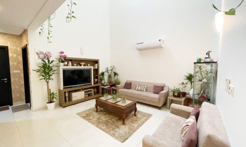 A spacious living room with a TV and plants in a luxury villa in Salmabad.