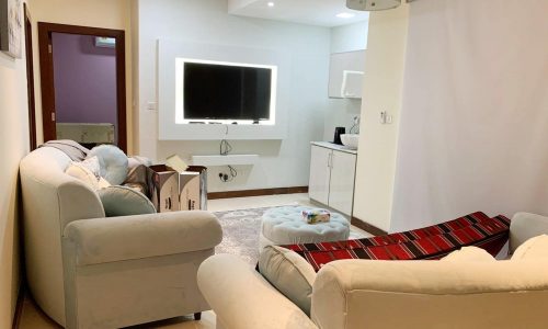 A white couch and tv in an Amazing 5BR Villa.