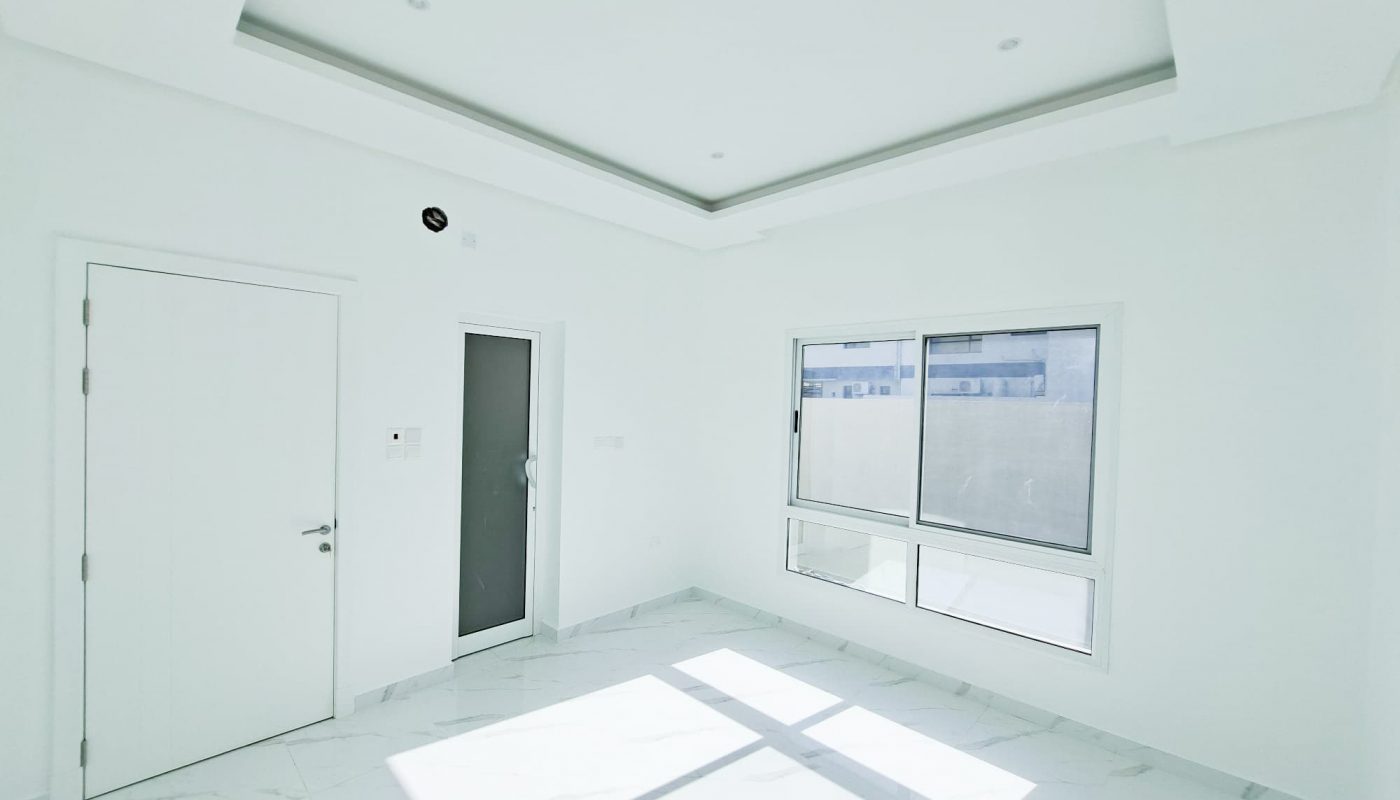 A luxury white room with a door and windows.