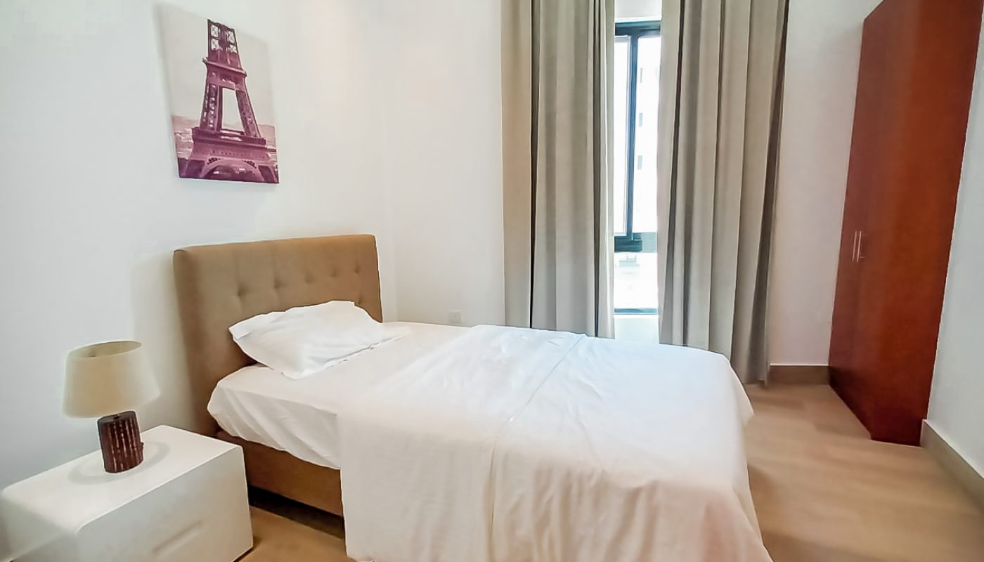 Keywords: Residential, Bed.
Description: A residential bedroom with a white bed and a painting on the wall.