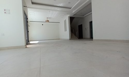 An empty room with a white tiled floor.