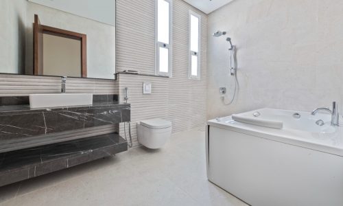 A bathroom with a tub and a sink is available for sale in the villa.