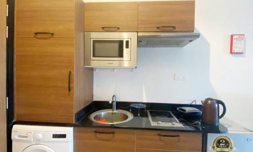 Luxury Studio for Rent in Busaiteen with small kitchen and washer.