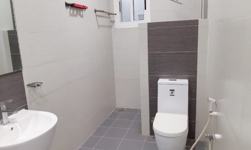 A small bathroom with a toilet and sink in a 3BR luxury apartment for sale in Shakhura.