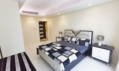 A black and white bedroom with a bed and dresser available for sale.