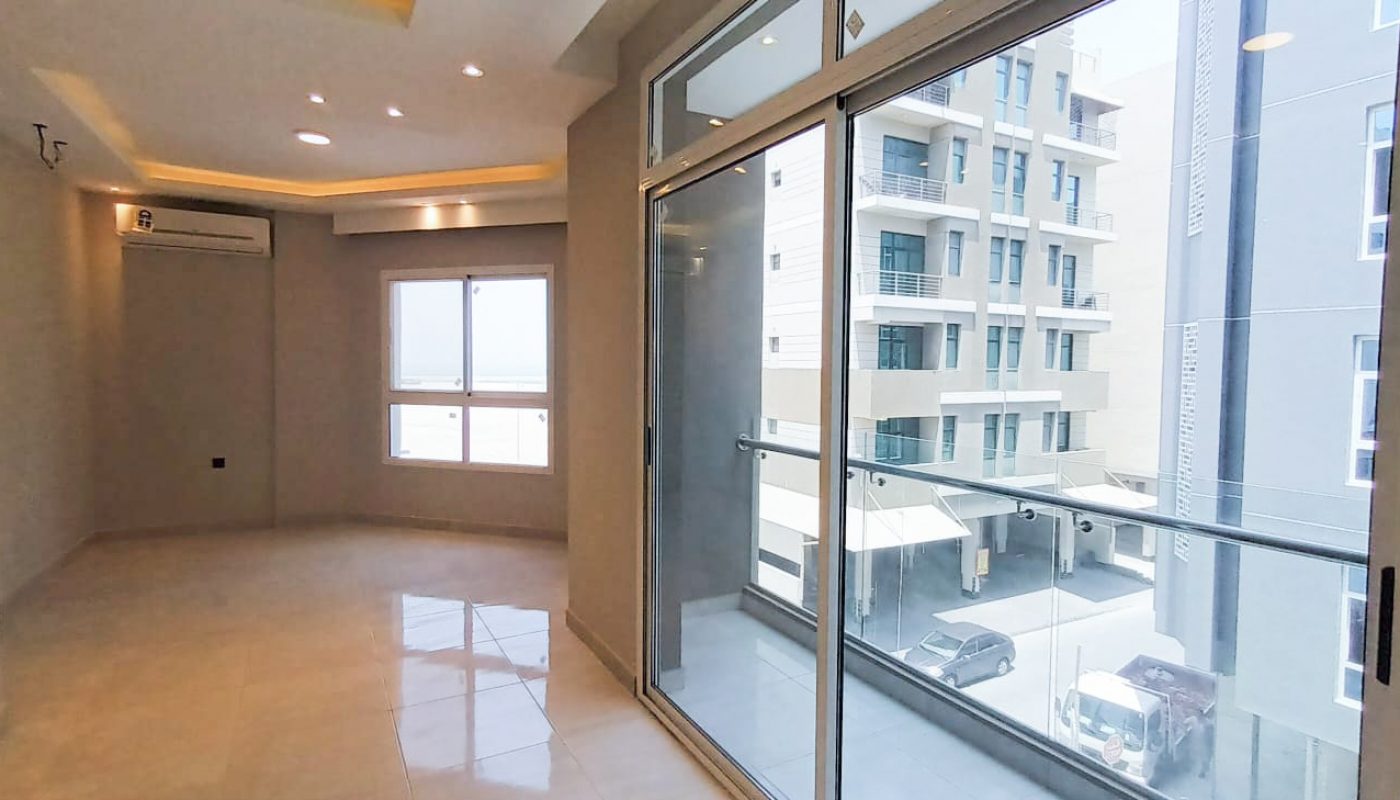 A brand new apartment with sliding glass doors and a view of the city.