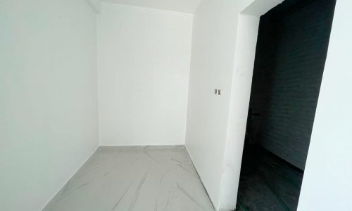 A spacious room with white walls and a luxurious white floor.