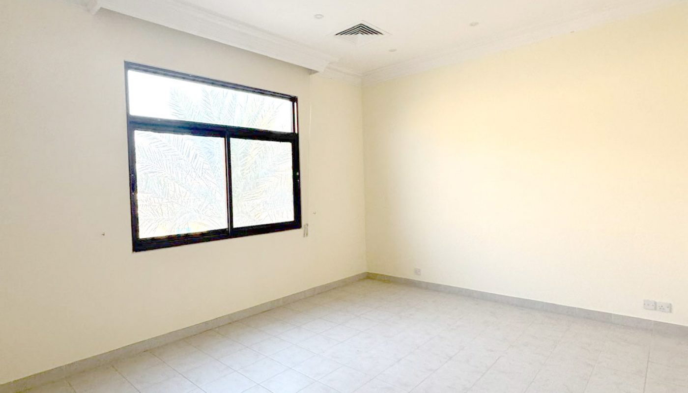 Empty room with white tiled floor, cream-colored walls, large window, and ceiling vents.