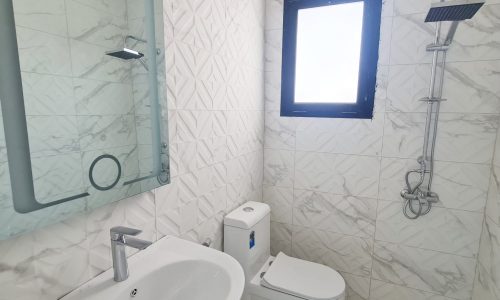 Brand New 3BR Villa with a white bathroom featuring a sink, toilet, and shower is available for sale.