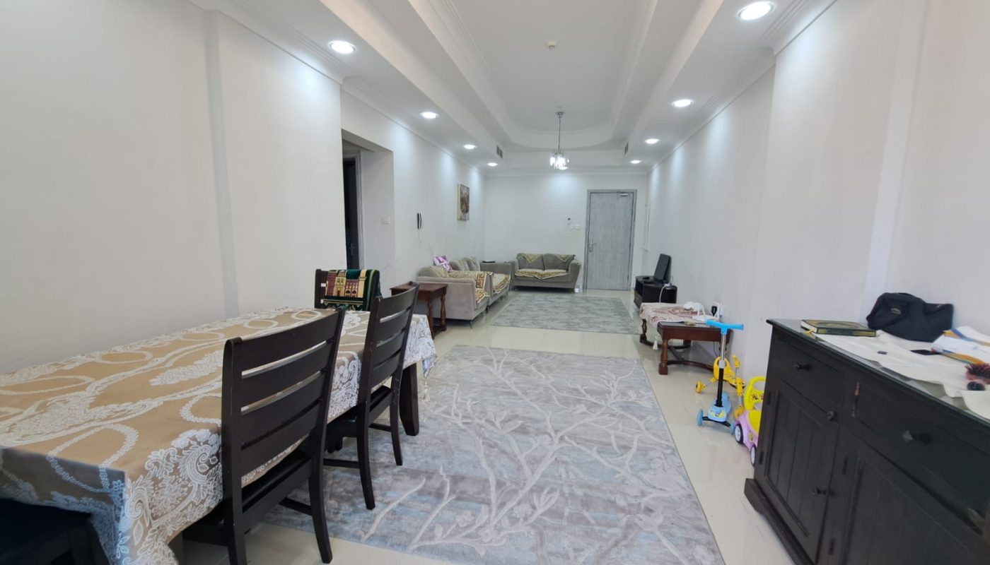 A furnished living room with a dining table and chairs.