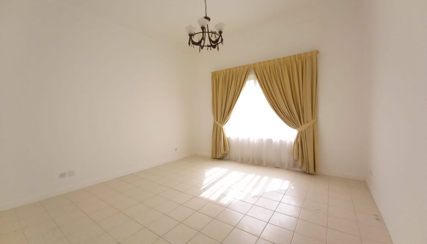 A room with a white tile floor and a chandelier.
