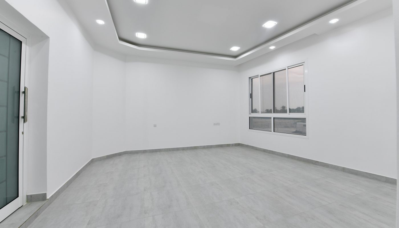 A luxurious apartment with white walls and a door, located near St. Christopher's School, available for sale.
