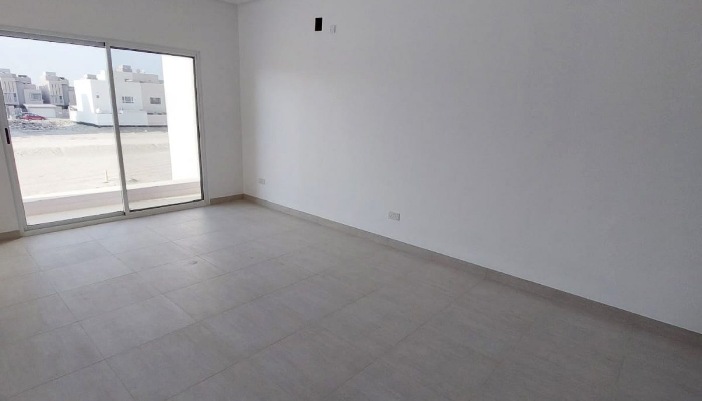 A spacious room with a sliding glass door.