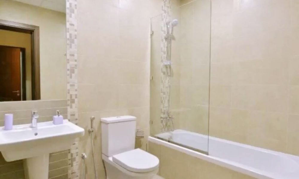 An amazing apartment for sale in Isa Town, featuring a bathroom with toilet, sink, and shower.