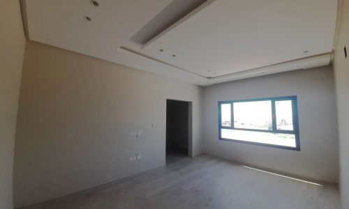 Stunning empty room with wooden floors and a window.