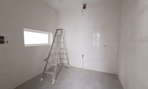 Cozy bathroom remodel with white tiles.