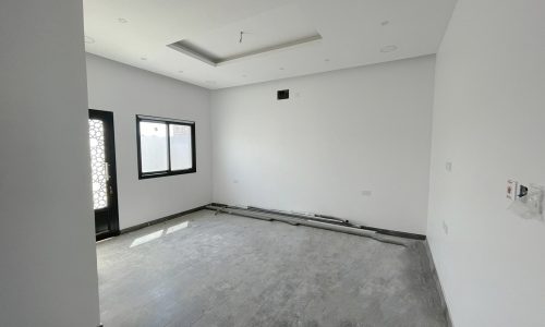 A bright room with white walls and wooden floors.