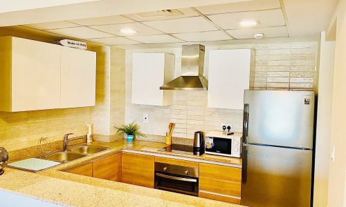 A modern kitchen with a sink and a refrigerator.