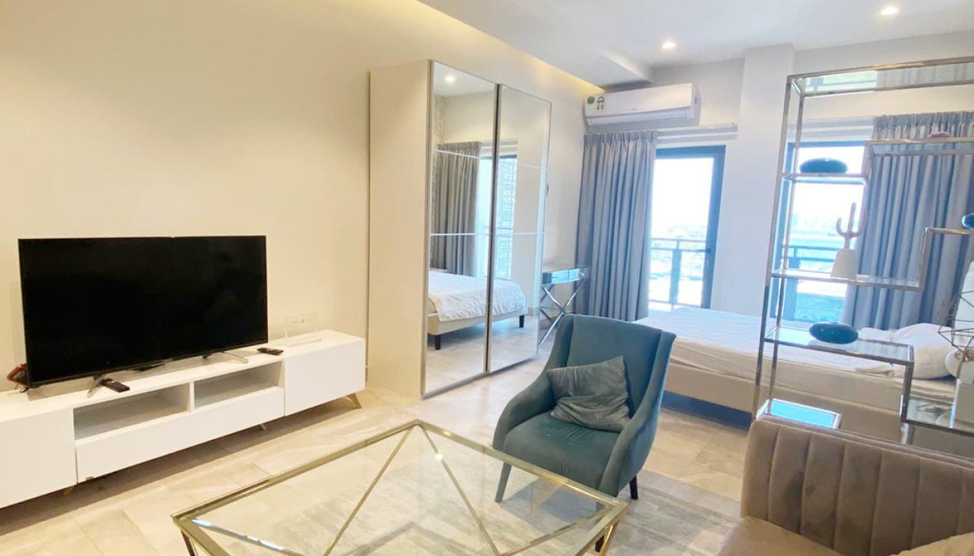 A luxury studio for rent in Busaiteen with a couch, coffee table, and TV.