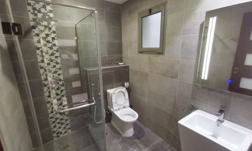 Luxury 3BR apartment for sale on Amwaj Island, featuring a bathroom with a toilet, sink, and shower.