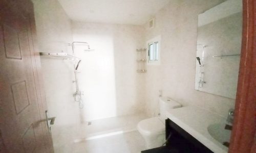 An apartment with a bathroom equipped with a toilet and a sink is available for sale.