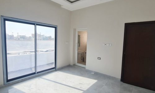 A spacious villa in Malkiyah with sliding glass doors and a balcony, available for sale.