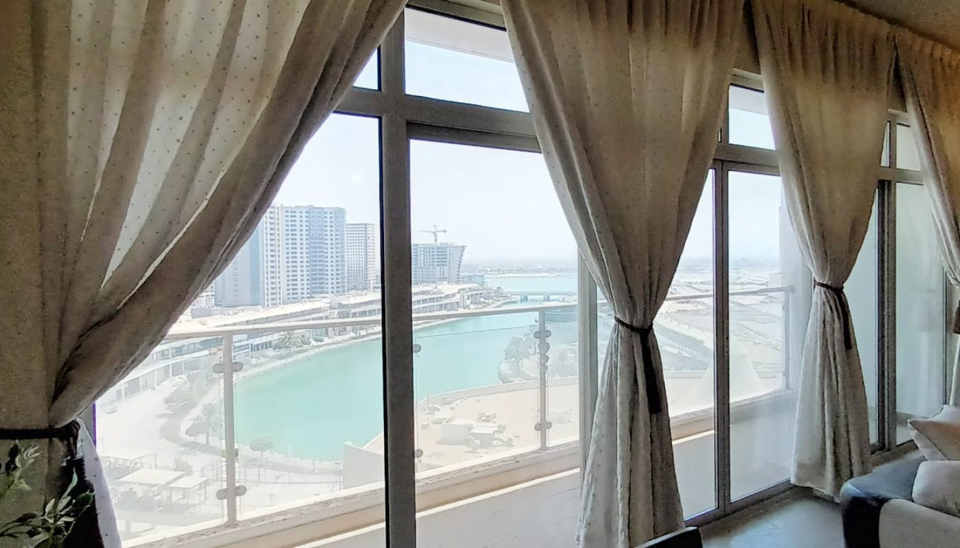 A modern apartment with a living room and a view of the city.