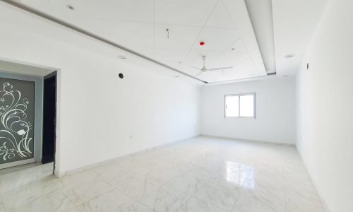 An empty room with white walls in a New Apartment for Sale in Riffa.