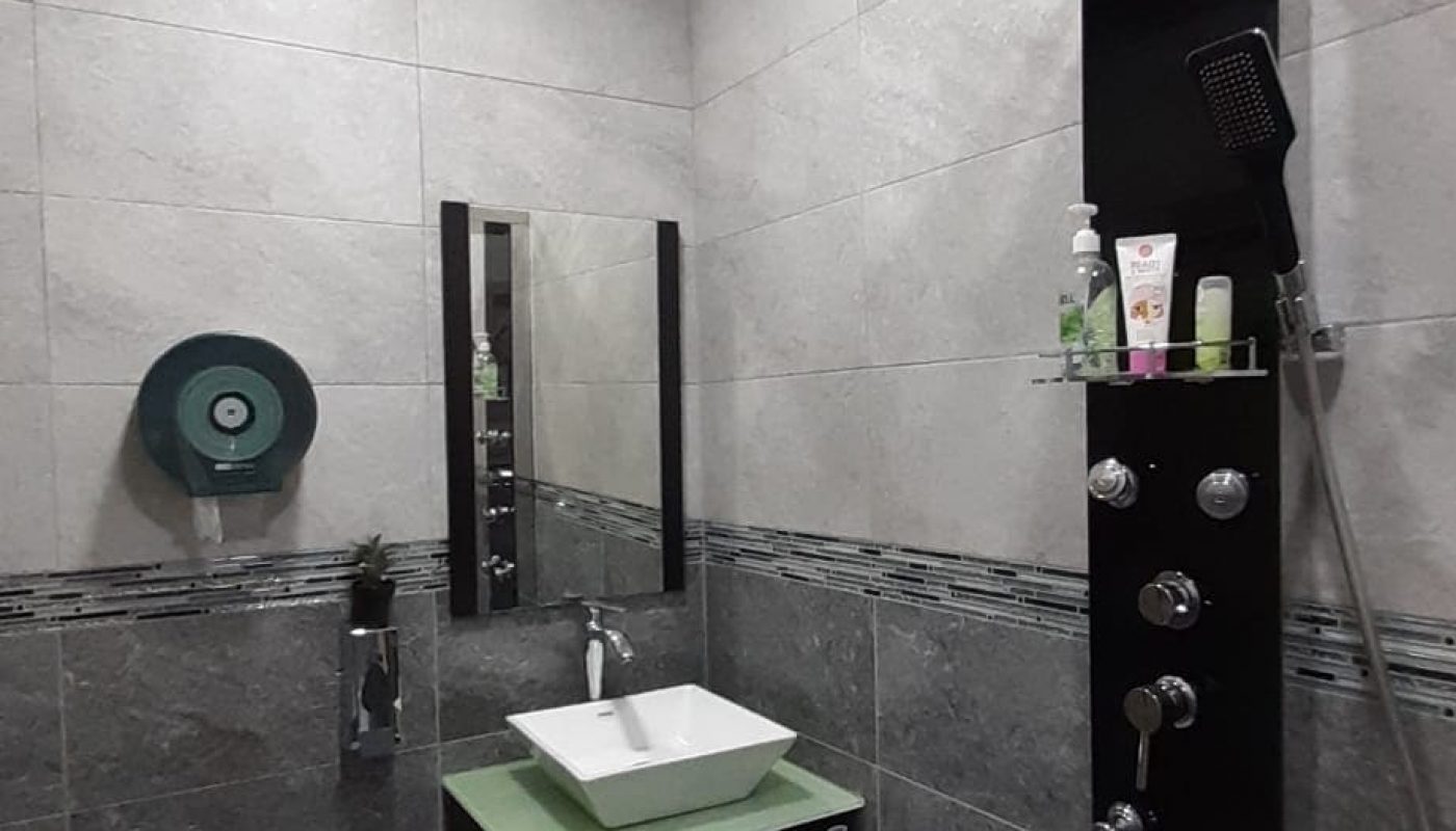 An apartment in Samaheej for sale with a shower, sink, and toilet.