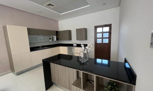 New luxury kitchen with black counter tops and white cabinets.