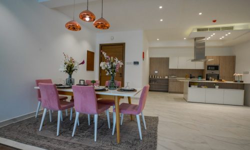 Spacious Apartment for Sale in Janabiyah with a dining room featuring pink chairs and a dining table.