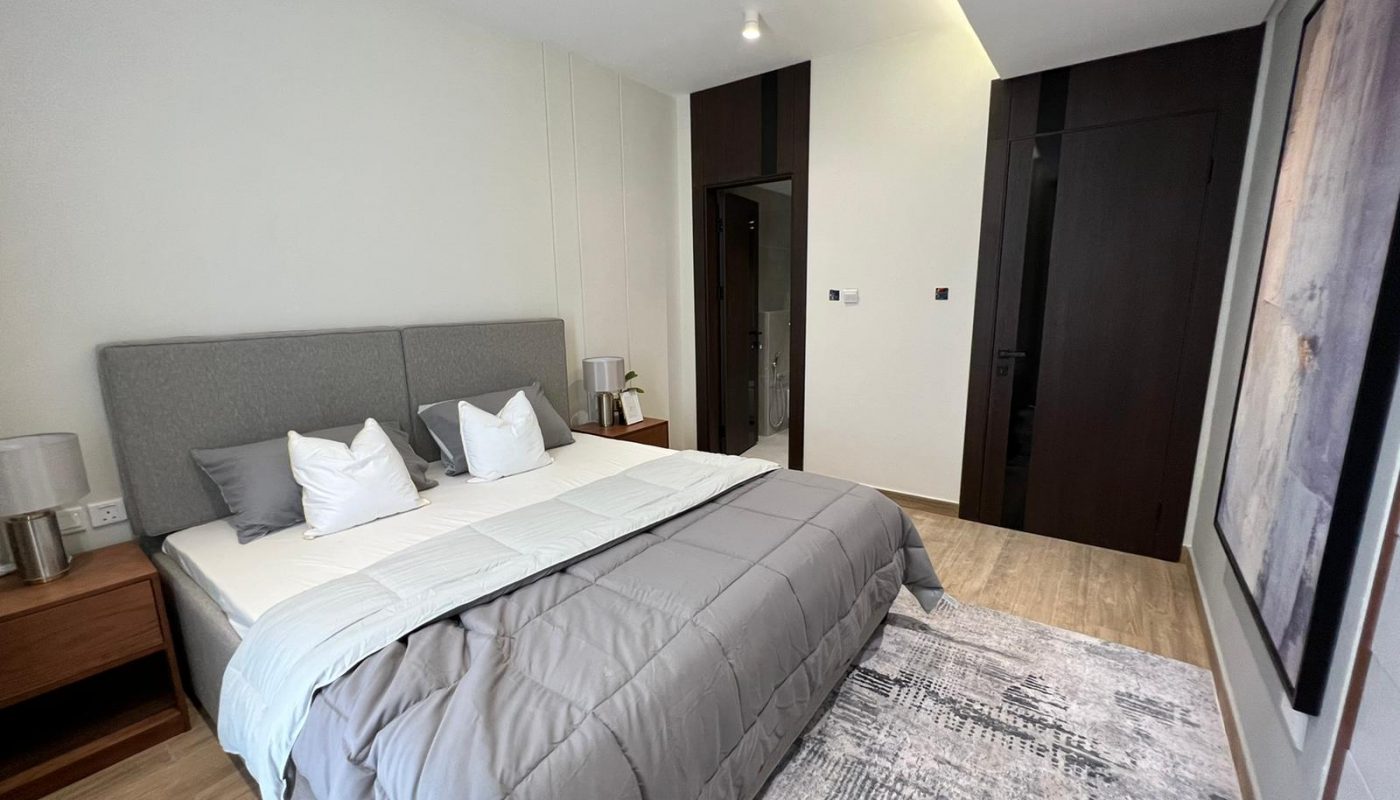 A stunning bedroom with a bed and a painting on the wall.