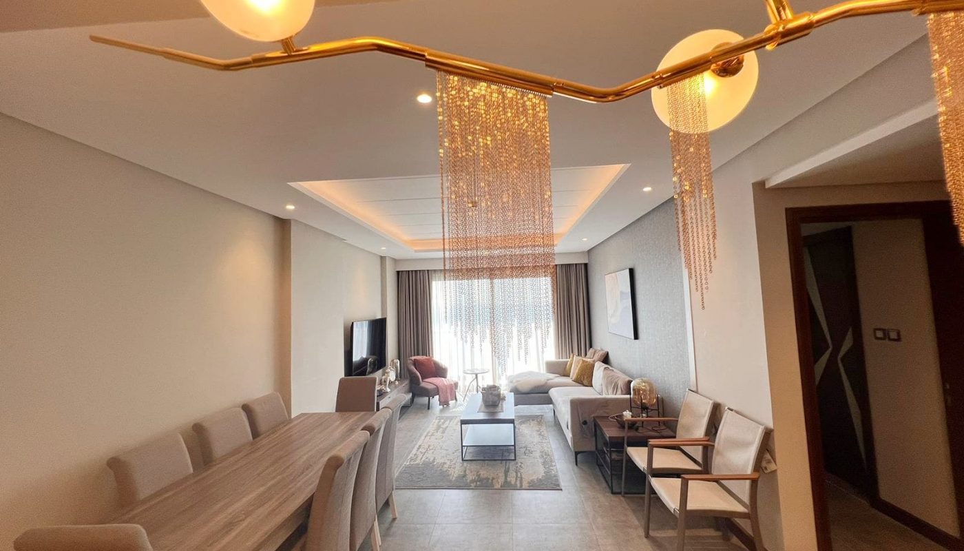 A spacious flat in Hidd Heights with a living room featuring a modern dining table and chairs.