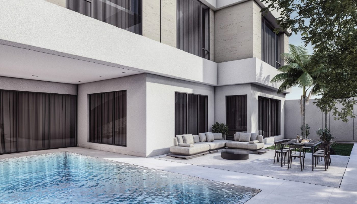 Modern white building with large glass windows, an outdoor swimming pool, a patio seating area, dining table, and surrounding greenery under a clear sky.